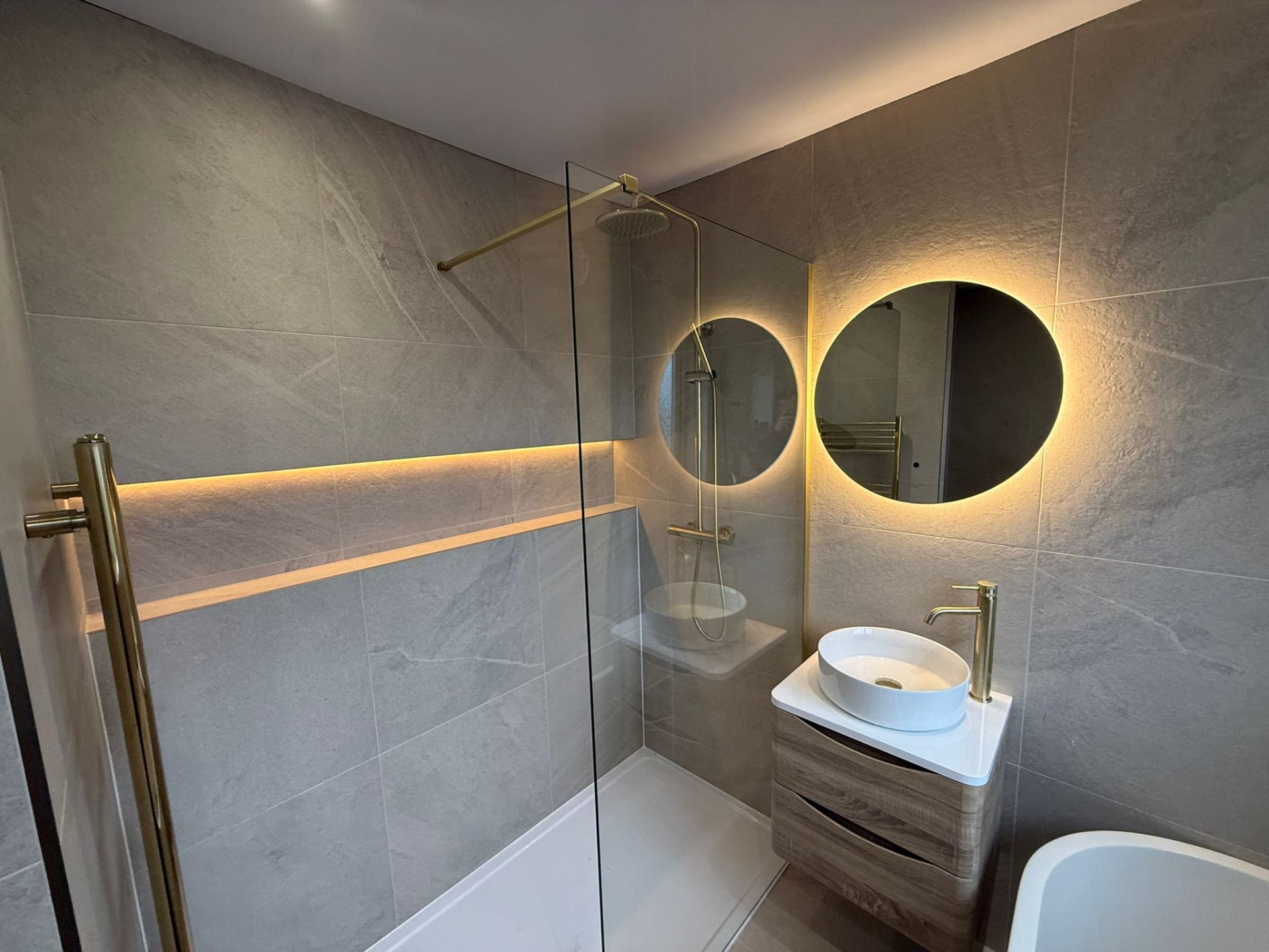 Renovated luxury bathroom in Greater Manchester with freestanding bath and statement tiles