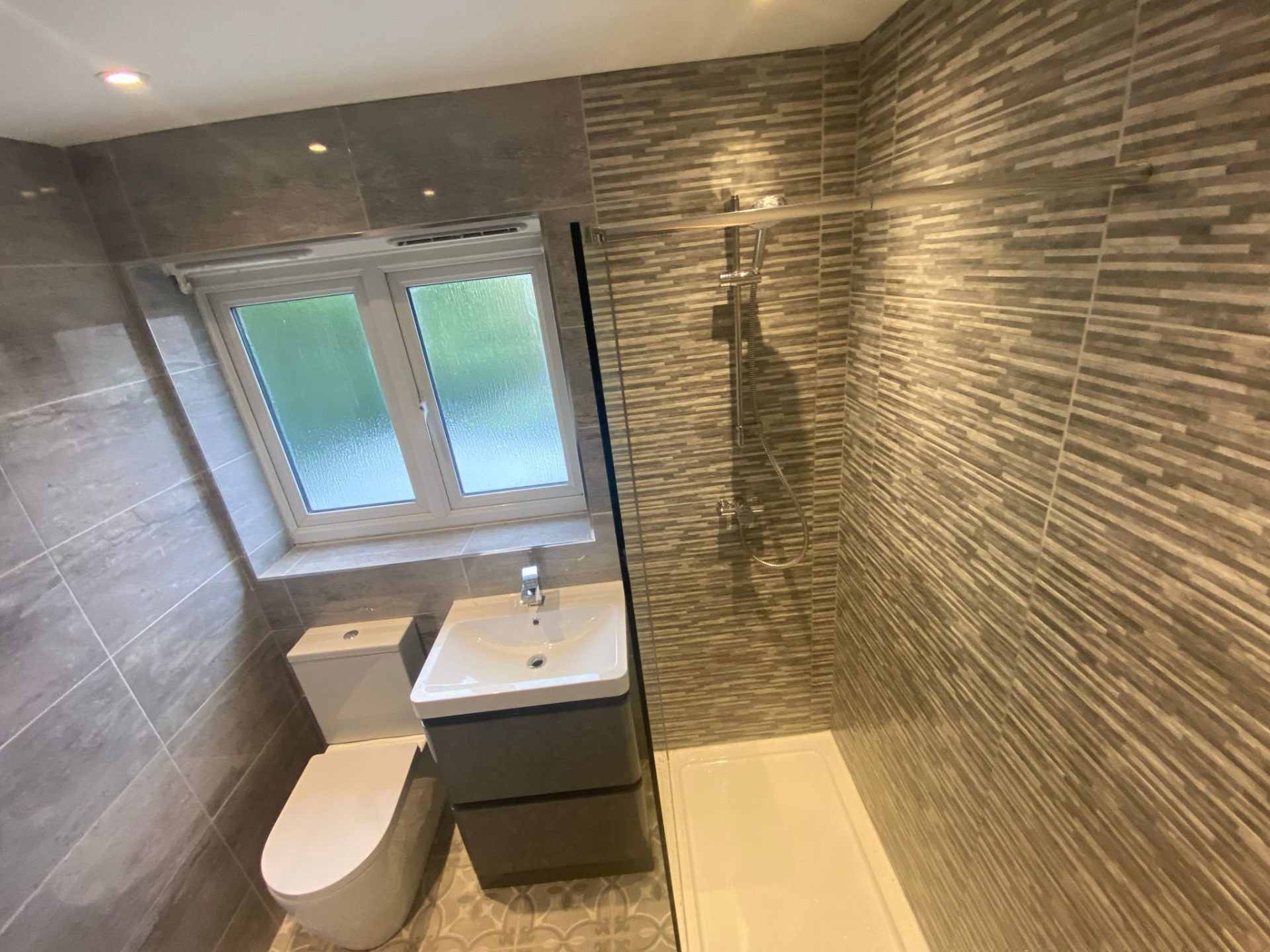 Modern kitchen with professional plumbing installation featuring mixer tap and undermount sink