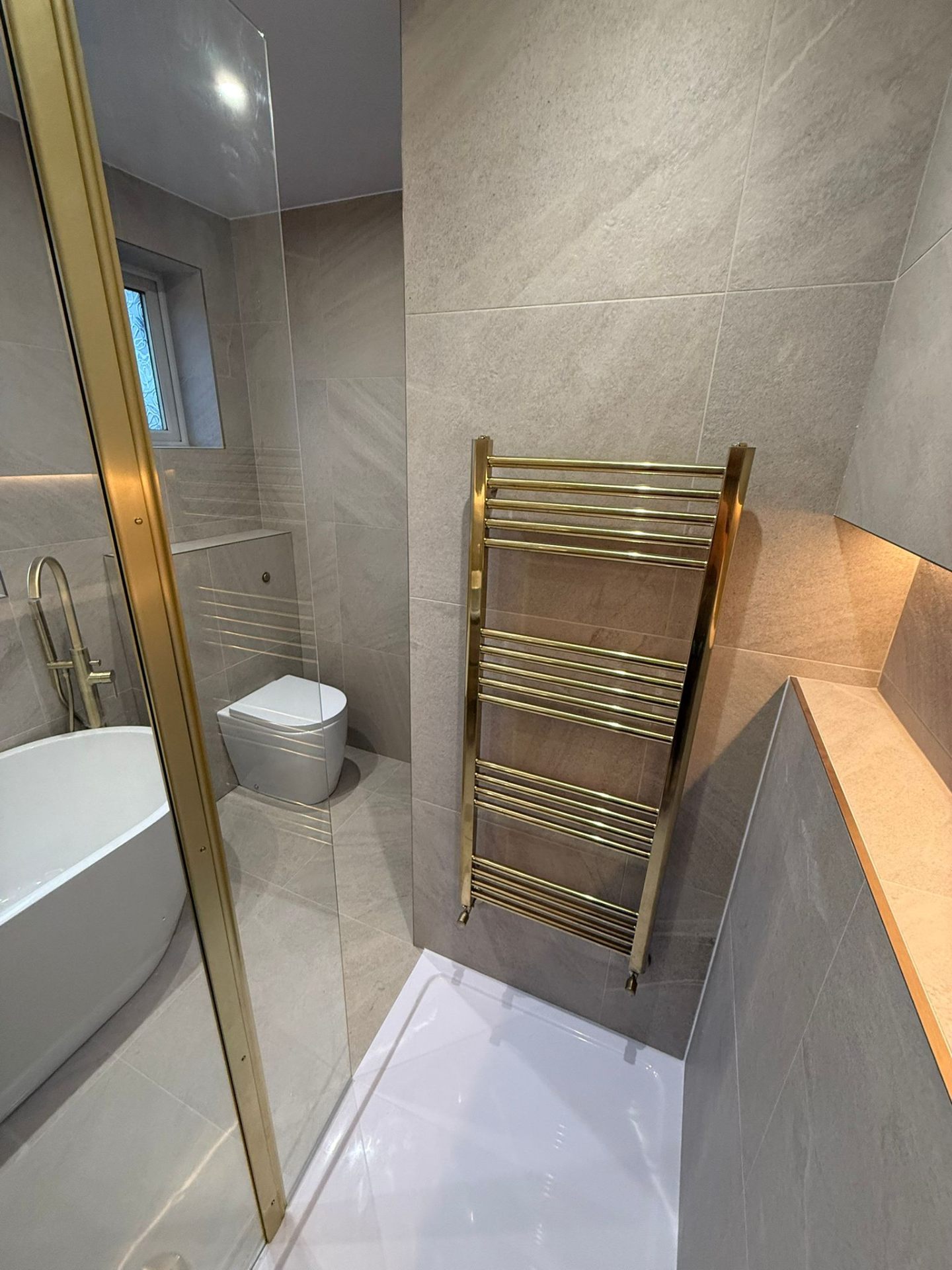 Gold Heated Towel Rail & Bath Installation by DPS Plumbing & Bathrooms in Heaton Moor, Stockport